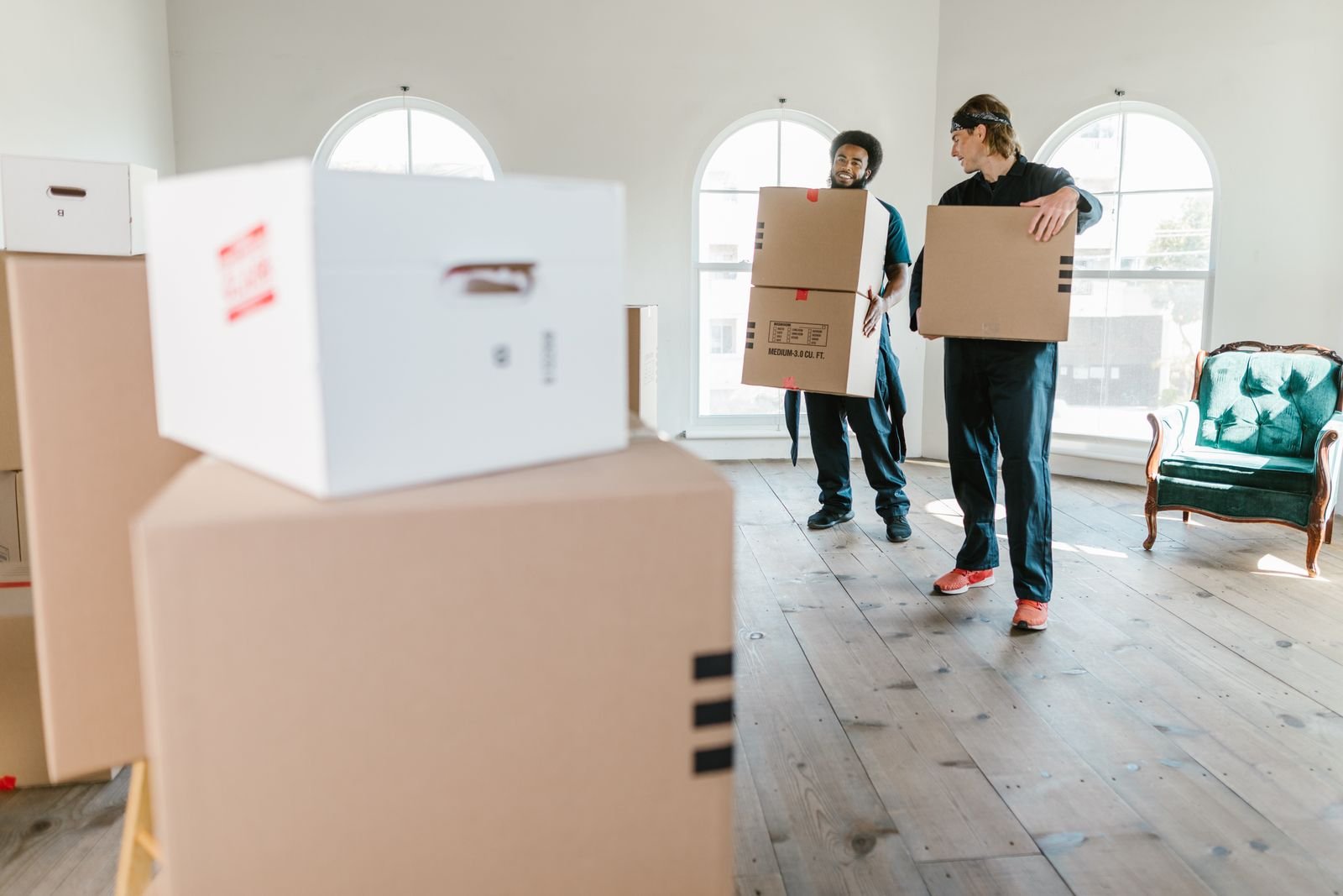 Movers carrying boxes on moving day